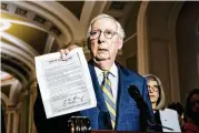  ?? MICHAEL A. MCCOY / NYT ?? Sen. Mitch McConnell (R-Ky.) holds a copy of a letter from U.S. Capitol Police Chief Tom Manger responding to Tucker Carlson’s use of January 6 footage during a news conference Tuesday in Washington.