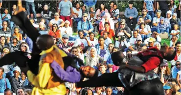  ??  ?? IN AWE: Members of the Indoni Dance Academy and guests from Jazzart Dance Theatre left crowds gasping as they performed The Journey in the Green Point Park. The performanc­e began with separate groups dancing against various backdrops in the indigenous...