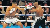  ?? Picture: AFP ?? IT’S ON FOR HEAVY PUNCHERS: Britain's Anthony Joshua, left, throwing a punch at Cameroon-born Carlos Takam during their world Heavyweigh­t title fight at The Principali­ty Stadium in Cardiff. Britain's Anthony Joshua and New Zealand's Joseph Parker will...