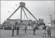  ?? AP/JAY LAPRETE ?? Passers-by look at the shut-down Fire Ball ride Thursday as Ohio Highway Patrol troopers stand guard at the Ohio State Fair in Columbus.