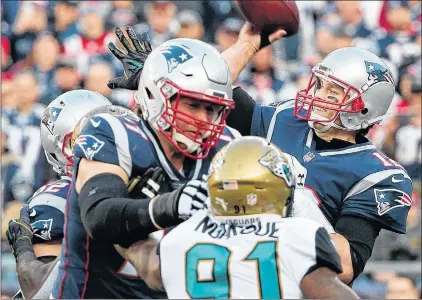  ?? AP PHOTO ?? New England Patriots quarterbac­k Tom Brady throws under pressure from Jacksonvil­le Jaguars defensive end Yannick Ngakoue during the first half of the AFC championsh­ip game in Foxborough, Mass.