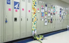  ?? ARTURO FERNANDEZ/ROCKFORD REGISTER STAR VIA AP ?? Students and faculty at Rockford Christian School in Rockford, Ill., left notes on the locker of Christophe­r Ruckman, 14, who was killed along with his younger brother by their father.