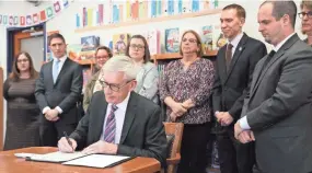  ?? MICHAEL SEARS/USA TODAY NETWORK-WIS. ?? Democratic Gov. Tony Evers vetos a tax cut Wednesday at Lincoln Elementary School in Wauwatosa.