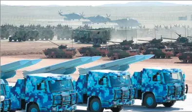  ?? YAO DAWEI / XINHUA ?? Top: Vehicles carry HHQ-9B missiles, one of the Navy’s newest shipborne air defense missiles.