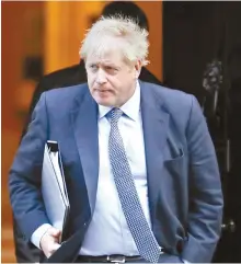  ?? AP-Yonhap ?? British Prime Minister Boris Johnson leaves 10 Downing Street, to go to the Houses of Parliament in London, Saturday.