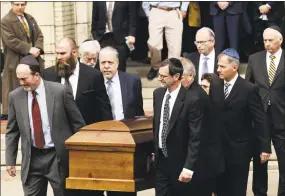  ?? Matt Rourke / Associated Press ?? A casket is carried out of Rodef Shalom Congregati­on after the funeral services for brothers Cecil and David Rosenthal on Tuesday in Pittsburgh. The brothers were killed in the mass shooting Saturday at the Tree of Life synagogue.