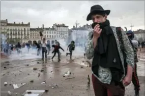  ?? LAURENT CIPRIANI — THE ASSOCIATED PRESS ?? People react during clashes with riot police Thursday during a protest in Lyon, central France.