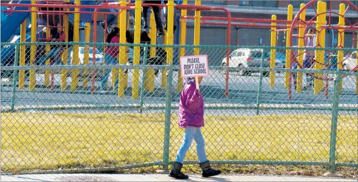  ??  ?? Second-grader Nyla Freeman walks with her picket sign near the playground area at William H. King Elementary School on South Campbell on Friday. | SCOTT STEWART~SUN-TIMES