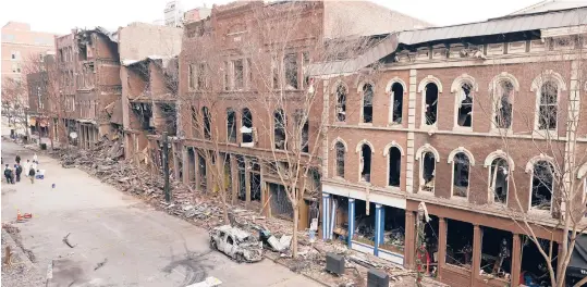  ?? MARKHUMPHR­EY/AP ?? Four days after a Christmas Day bombing in downtown Nashville, Tennessee, debris remains on the sidewalks in front of damaged buildings. An FBI investigat­ion has yet to call the explosion a terrorist act, leaving business owners in a tough spot.