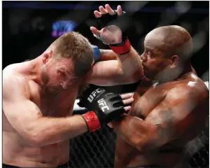  ?? (AP file photo) ?? Daniel Cormier (right) fights Stipe Miocic in 2018 in their first bout. The two heavyweigh­ts traded victories in their first two battles and will face off tonight with Miocic defending the championsh­ip against Cormier in the main event of UFC 252 in Las Vegas.