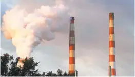  ?? MARK WILSON/GETTY ?? Emissions spew out of a large stack at the coal-fired Morgantown Generating Station on Oct. 10, 2017. The plant will stop burning coal in 2027, officials have announced.