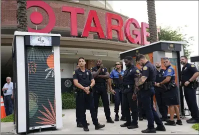  ?? (AP) ?? Police stand outside a Target store as a group of people across the street protest against Pride displays in the store on June 1, 2023, in Miami.