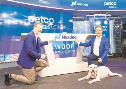  ?? NASDAQ ?? Petco CFO Michael Nuzzo (left) and CEO Ron Coughlin, with his dog, participat­ed in the Nasdaq opening bell ceremony.