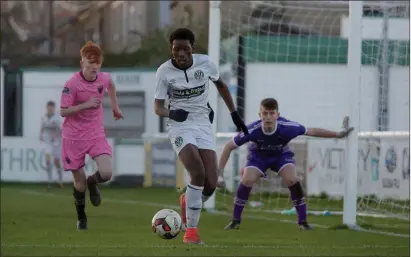  ??  ?? Destiny Idele of Bray Wanderers is closed down by Graham O’Reilly of Wexford F.C., with netminder Cian Browne alert at his near post.