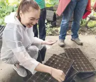  ??  ?? The author hoping to one day reap what she sowed — lots of lettuce!