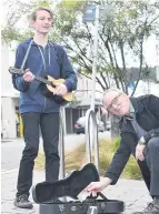  ??  ?? Trent Hawthorne practising in King Edward St recently, with South Dunedin Business Associatio­n chairman Craig Waterhouse offering support.