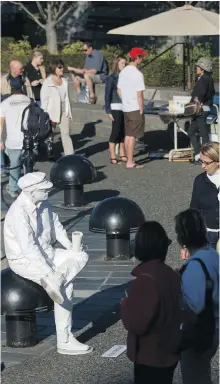  ?? DEBRA BRASH, TIMES COLONIST ?? Clark M. Clark, as the Plasterman, catches the eye of people strolling the Inner Harbour in September 2009.