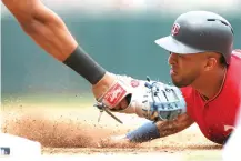  ?? Stacy Bengs/Associated Press ?? ■ Minnesota Twins' Eddie Rosario is tagged out at first base by Texas Rangers' Ronald Guzman in the third inning of a baseball game Sunday in Minneapoli­s.