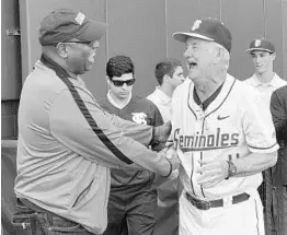  ?? JOSEPH REEDY/ASSOCIATED PRESS ?? FSU AD Stan Wilcox, left, congratula­tes baseball coach Mike Martin on his 1,900th win last year in Tallahasse­e. Wilcox is leaving the AD post he’s had at FSU since 2013.