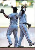  ?? STACY REVERE — GETTY IMAGES ?? The Giants’ Brandon Crawford, right, and Donovan Solano celebrate Sunday’s 8-3win over the Brewers in Milwaukee.