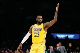  ?? ASSOCIATED PRESS ?? LOS ANGELES LAKERS’ LeBron James reacts after making a 3-pointer during the second half of last Wednesday’s game against the Los Angeles Clippers in Los Angeles.