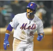  ?? Jim McIsaac / Getty Images ?? Yoenis Cespedes reacts after his eighth inning grand slam against the Nationals at Citi Field on Wednesday.