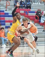  ?? Michelle Petteys, Heritage Snapshots ?? Senior Caden Snyder drives the lane during the Generals’ playoff game versus Mays this past Wednesday. The Raiders would open things up in the fourth quarter to score a 60-43 victory.