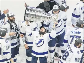  ?? JASON FRANSON— THE CANADIAN PRESS VIA AP ?? Tampa Bay Lightning’s Nikita Kucherov hoists the Stanley Cup after defeating the Dallas Stars in the Stanley Cup hockey finals in Edmonton, Alberta, on Monday.