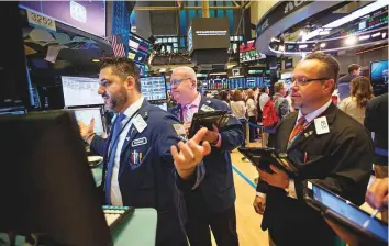  ?? Bloomberg ?? Traders at the New York Stock Exchange. The slide in US stocks picked up speed on Friday, with the S&amp;P 500 Index extending losses from its September record to 10 per cent.