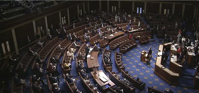  ?? AP ?? SAFE VOTING: Members of the House practice social distancing during debate on the coronaviru­s stimulus package at the House of Representa­tives at the U.S. Capitol in Washington, D.C., on Friday.