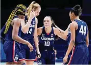  ?? Jeff Dean / Associated Press ?? UConn's Aaliyah Edwards, left, Dorka Juhasz (14), Nika Muhl (10) and Aubrey Griffin (44) huddle prior to a game against Xavier.