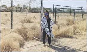  ?? JULIE DRAKE/VALLEY PRESS ?? Kathya Arriaran-Buono, principal of Palmdale Academy Charter High School, stands next to a 32-acre lot that will be cleared of tumbleweed­s and vegetation under a contract with the Palmdale School District.