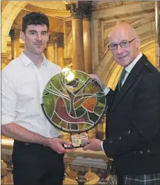  ??  ?? Alasdair Whyte receives the Gaelic Ambassador of the Year Award from John Swinney MSP.