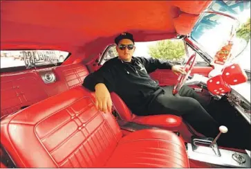  ?? Genaro Molina Los Angeles Times ?? JONATHAN RODRIGUEZ, 20, spent part of the pandemic lockdown souping up a 1963 Chevy Impala Super Sport lowrider. His hard work paid off: The Long Beach resident sold the car to a buyer in Florida for $150,000.