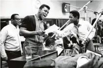  ?? Michael Ochs Archives / Getty Images ?? Sam Cooke, right, who was active in the civil rights movementis, is pictured with Muhammad Ali, center.