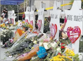  ?? Gene J. Puskar ?? The Associated Press Flowers surround Stars of David, part of a makeshift memorial outside Pittsburgh’s Tree of Life Synagogue to the 11 people killed during worship services Saturday.