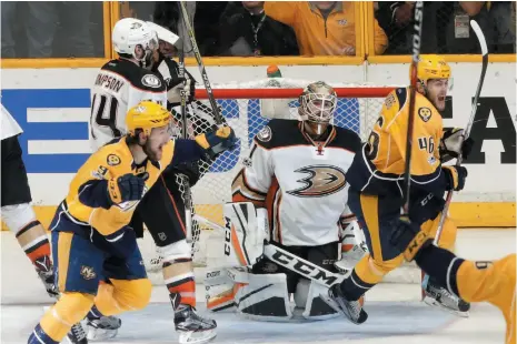  ?? AP PHOTO ?? Anaheim Ducks goalie Jonathan Bernier kneels on the ice as Nashville Predators’ Filip Forsberg and Pontus Aberg celebrate a goal by teammate Colton Sissons, not shown, during Game 6 of the Western Conference final ion Monday in Nashville, Tenn. Sissons...