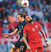  ?? AP ?? Chile’s Arturo Vidal vies for the ball with Australia’s Jackson Irvine (left) during the Group B match.