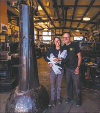  ?? COURTESY PHOTO ?? Christina Sporrong and Christian Ristow at Spitfire Forge – their massive mechanical sculpture ‘Capsule’ will be installed soon in Arroyo Seco.