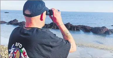  ??  ?? A Britain First member on beach patrol