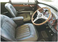  ??  ?? The interior was upgraded with luxurious leather sports seats and a matching central armrest.Rich dark woodgrain dashboard with dials by instrument maker Smiths and a wood-trimmed Moto-Lita three-spoke steering wheel