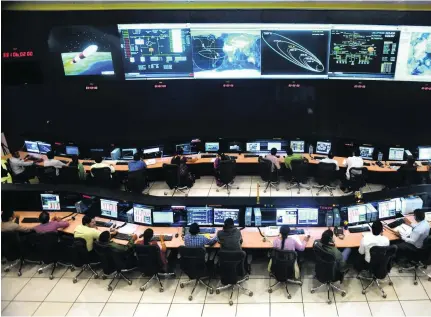  ?? Manjunath Kiran /AFP Photo ?? Indian scientists and engineers from the Indian Space Research Organisati­on monitor the Mars Orbiter Mission at the ISRO telemetry, tracking and command centre in Bangalore, India.