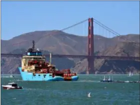  ?? LORIN ELENI GILL — THE ASSOCIATED PRESS ?? A ship tows The Ocean Cleanup’s first buoyant trash-collecting device toward the Golden Gate Bridge in San Francisco en route to the Pacific Ocean on Saturday. Once deployed, the boom will form a U-shaped barrier to trap plastic and trash that currently makes up the “Great Pacific Garbage Patch.”