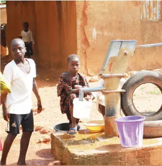  ??  ?? Children draw water from a bolehole drilled by KRPC