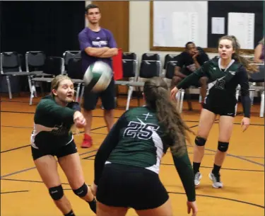  ?? MIKE BUSH/NEWS-SENTINEL ?? Elliot Christian outside hitter Kayleigh Schrader sets the volleyball up for teammates Sophia Butler (25) and Lexie Juelch (13) in Wednesday's CCAA home match against Venture Academy.