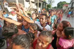  ??  ?? People queue to receive food donations. — Reuters photo