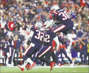  ?? Adam Glanzman / Getty Images ?? The Patriots defense celebrates during the second half against the Colts on Thursday night.