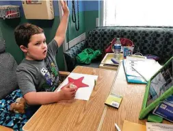  ?? Courtesy Methodist Children’s Hospital ?? Colton Higgins, 7, an outpatient at Methodist Children’s Hospital, raises his hand as he works on an art project as part of Hemisfair’s Virtual Story Time program and STEAM-related activities. The weekly remote program is a collaborat­ion between the nonprofit and Methodist Children’s Hospital.