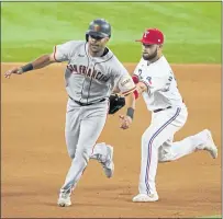  ?? TONY GUTIERREZ – THE ASSOCIATED PRESS ?? The Giants’ LaMonte Wade Jr. left, is tagged out by Rangers third baseman Isiah Kiner-Falefa during the 11th inning on Wednesday.