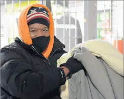  ??  ?? Rodney Madison, of Tinley Park, had a blanket and pillow for a 28-hour wait at Orland Park’s GameStop hoping for a Sony PlayStatio­n 5.